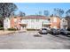 Brick front exterior of a two-story townhome building with parking at 4008 Orchard Hill Ter, Stone Mountain, GA 30083