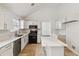 Bright kitchen with white cabinets, stainless steel appliances, and tile floors at 4682 Centurian Way Vw, Snellville, GA 30039