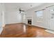 Bright living room featuring a fireplace, hardwood floors, white walls, and large windows at 4682 Centurian Way Vw, Snellville, GA 30039