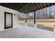 Covered patio with concrete flooring and wooded views at 744 Riverside Rd, Sugar Hill, GA 30518