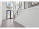 Bright and airy entryway with frosted glass double doors and modern staircase at 744 Riverside Rd, Sugar Hill, GA 30518