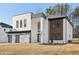 Contemporary two-story house with white brick and wood accents, three-car garage at 744 Riverside Rd, Sugar Hill, GA 30518