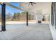 Covered back patio featuring a fireplace, ceiling fan, and expansive backyard view at 1010 Nours Cir, Lawrenceville, GA 30045
