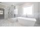 Bathroom includes a soaking tub, glass shower, and marble tile at 1010 Nours Cir, Lawrenceville, GA 30045