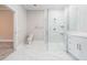Bathroom featuring a glass enclosed shower with marble tile surround, white vanity and toilet at 1010 Nours Cir, Lawrenceville, GA 30045
