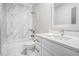 Bright bathroom with marble tile, shower-tub combo, and white vanity with quartz countertop at 1010 Nours Cir, Lawrenceville, GA 30045
