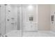 Bright bathroom featuring a glass enclosed shower with marble tile surround and white vanity at 1010 Nours Cir, Lawrenceville, GA 30045