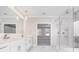 Bathroom features a dual sink vanity, glass shower, and marble tile at 1010 Nours Cir, Lawrenceville, GA 30045