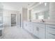 Bright bathroom boasts marble floors, a double vanity, and a walk-in closet at 1010 Nours Cir, Lawrenceville, GA 30045