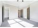 Bedroom with a carpeted floor, tray ceiling, and doors to the closet and the bathroom at 1010 Nours Cir, Lawrenceville, GA 30045