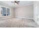 Spacious bedroom with carpet floors, large window, and view to ensuite bathroom at 1010 Nours Cir, Lawrenceville, GA 30045