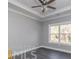 Simple bedroom with gray walls and dark hardwood floors at 1010 Nours Cir, Lawrenceville, GA 30045