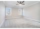 Bedroom with a carpeted floor, ceiling fan, and two windows at 1010 Nours Cir, Lawrenceville, GA 30045