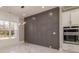 A dining space showcases a custom wall, stainless steel appliances, and marble floors for a modern feel at 1010 Nours Cir, Lawrenceville, GA 30045