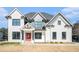 Charming two-story home with a red front door, black framed windows, and ample parking space at 1010 Nours Cir, Lawrenceville, GA 30045