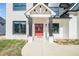 Close-up of a home's entrance featuring a red door, sleek black accents, and a welcoming walkway at 1010 Nours Cir, Lawrenceville, GA 30045
