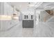 Modern white kitchen with gray island, stainless appliances and bright, marble floors at 1010 Nours Cir, Lawrenceville, GA 30045