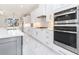 Bright kitchen features marble countertops, stainless steel appliances, and white cabinets at 1010 Nours Cir, Lawrenceville, GA 30045