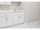 Clean laundry room featuring white cabinets, a quartz countertop, and marble tile floors at 1010 Nours Cir, Lawrenceville, GA 30045