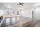 Bright living room showcasing hardwood floors, a ceiling fan, and a modern fireplace at 1010 Nours Cir, Lawrenceville, GA 30045