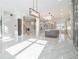 Open floor plan showcasing living room and modern kitchen with island and marble floors at 1010 Nours Cir, Lawrenceville, GA 30045