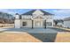 Stunning rear exterior of a two-story home with a covered patio and spacious backyard at 1010 Nours Cir, Lawrenceville, GA 30045