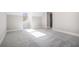 A room with a sloped ceiling, carpeted floor, and a window at 1010 Nours Cir, Lawrenceville, GA 30045