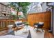 Relaxing backyard patio with seating area and wooden fence at 1170 Brookhaven Woods Ne Ct, Atlanta, GA 30319