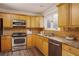 Well-equipped kitchen with light wood cabinets and granite countertops at 1170 Brookhaven Woods Ne Ct, Atlanta, GA 30319