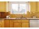 Kitchen features light wood cabinets, granite countertops, and double sink at 1170 Brookhaven Woods Ne Ct, Atlanta, GA 30319