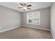 Bright bedroom with ceiling fan, large window, and neutral carpeting at 2071 Imperial Pond, Powder Springs, GA 30127