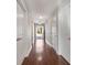 Long hallway with hardwood floors and neutral-toned walls at 2071 Imperial Pond, Powder Springs, GA 30127