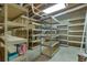 Unfinished basement with ample shelving for storage at 3405 Doral Ln, Woodstock, GA 30189