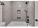 Clean bathroom with gray tile shower, tub and black fixtures at 3405 Doral Ln, Woodstock, GA 30189