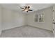 Spacious bedroom featuring neutral walls, carpet, and a ceiling fan at 3405 Doral Ln, Woodstock, GA 30189