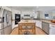 Spacious kitchen featuring stainless steel appliances and light wood cabinetry at 3405 Doral Ln, Woodstock, GA 30189