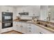 Modern kitchen with stainless steel sink and white cabinets at 3405 Doral Ln, Woodstock, GA 30189