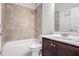 Simple bathroom with a shower/tub combo and dark brown vanity at 4200 Oxcliffe Grv, Suwanee, GA 30024