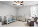 Charming bedroom with crib, dresser and comfy armchair at 4200 Oxcliffe Grv, Suwanee, GA 30024