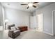 Spacious bedroom with built-in shelving and an armchair at 4200 Oxcliffe Grv, Suwanee, GA 30024