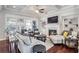 Open concept living room with coffered ceiling, fireplace and built-in shelving at 4200 Oxcliffe Grv, Suwanee, GA 30024