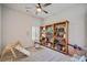 bedroom with toy shelves, a play area, and plenty of natural light at 6285 Vista Crossing Way, Cumming, GA 30028