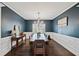 Elegant dining room features dark hardwood floors and a stunning chandelier at 6285 Vista Crossing Way, Cumming, GA 30028