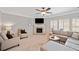 Cozy Gathering room features neutral tones, fireplace, and ample natural light at 6285 Vista Crossing Way, Cumming, GA 30028