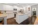 Modern kitchen with white cabinets, granite countertops, and large island at 6285 Vista Crossing Way, Cumming, GA 30028