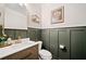 Elegant powder room features a modern vanity, decorative wall paneling, and gold accents at 6285 Vista Crossing Way, Cumming, GA 30028