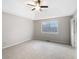 Spacious bedroom with large window and ceiling fan at 1508 Towne Harbor Ln, Woodstock, GA 30189