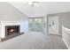 Bright living room with brick fireplace and bay window at 1508 Towne Harbor Ln, Woodstock, GA 30189