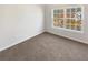 Well-lit bedroom with a large window and neutral carpet at 169 Hunters, Mcdonough, GA 30253