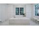 Elegant bathroom with soaking tub, marble flooring, and ample storage at 3382 Habersham Nw Rd, Atlanta, GA 30305